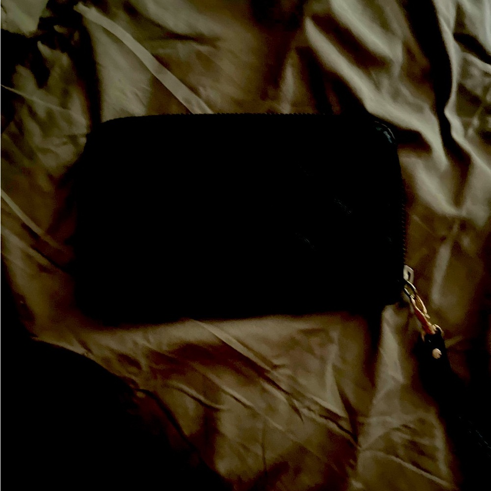 Black quilted zip around wallet.
